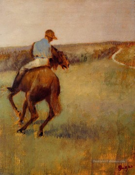 jockey en bleu sur un cheval marron Edgar Degas Peinture à l'huile